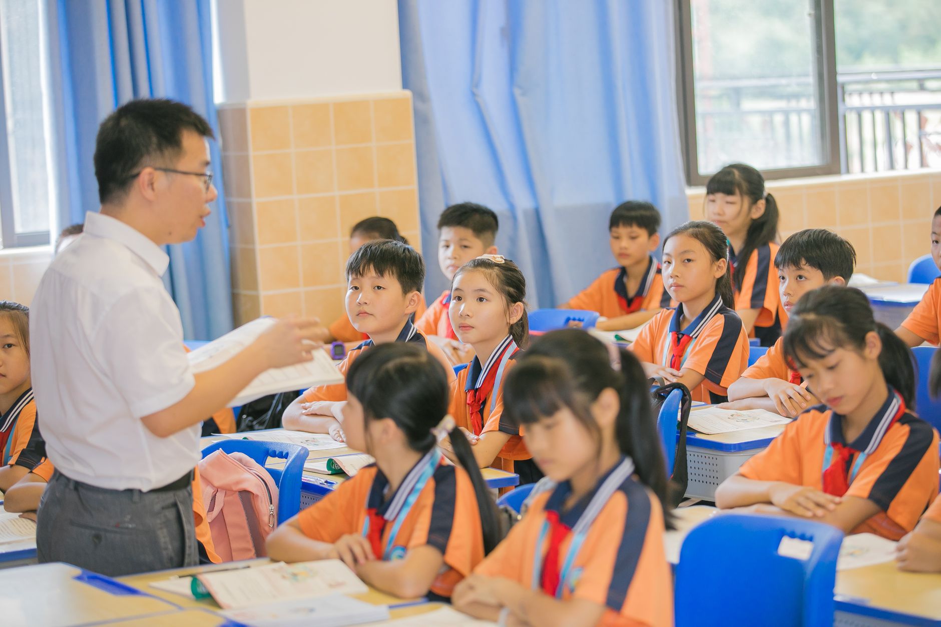 Asian teacher conducting a lesson with attentive students in a bright classroom setting. — The Best Online Slots: A Comprehen